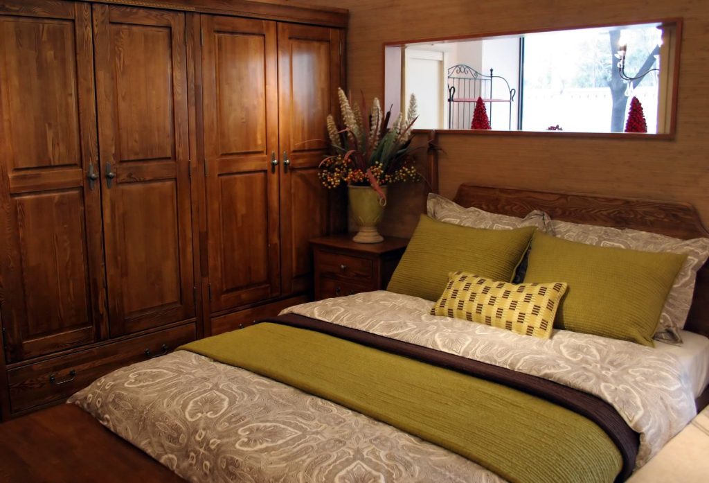 DIY Wardrobe planner - bedroom with green bed linen and wooden wardrobe
